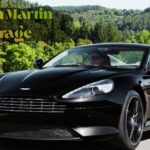 Black Aston Martin Virage luxury sports car driving at high speed.