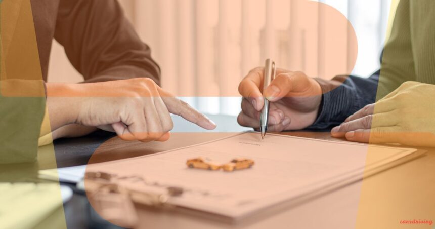 Close-up of a person pointing to a document while another signs a contract, representing a vehicle spec check or buying a car by registration number.