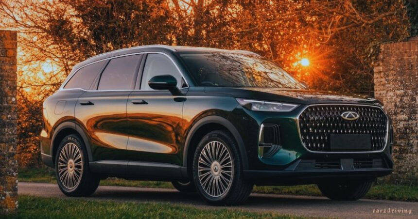 A dark green Chery Tiggo 9 SUV parked on a roadside path during a vibrant golden hour sunset, with trees and a brick wall in the background.
