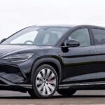 BYD black electric SUV coupe on UK road representing the rise of Chinese cars in the UK market