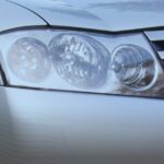 Close-up of the front headlight assembly and chrome grille of a silver Infiniti M45S sedan.