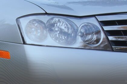 Close-up of the front headlight assembly and chrome grille of a silver Infiniti M45S sedan.