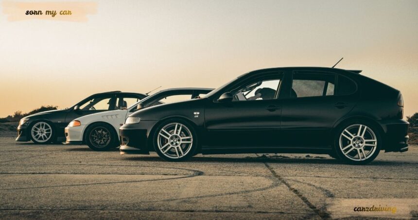 Three modified cars parked on an airfield at sunset, ideal for drivers looking for a guide on how to sorn my car in the UK.