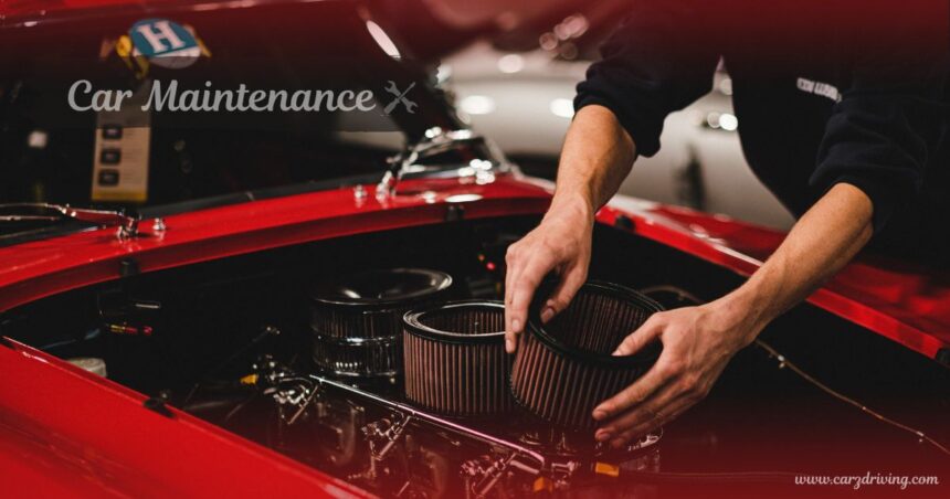 Mechanic replacing engine air filters during routine car maintenance on a classic red car