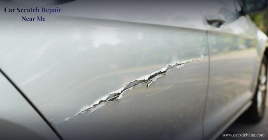 Close-up of a deep gash and paint damage on a silver car door, illustrating the need for professional car scratch repair near me