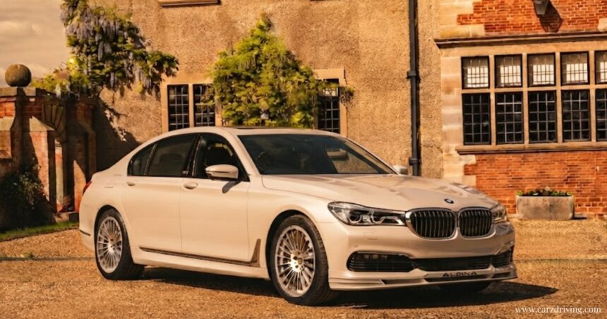 Alpina BMW luxury sedan parked in front of a classic home, showcasing signature multi-spoke wheels.