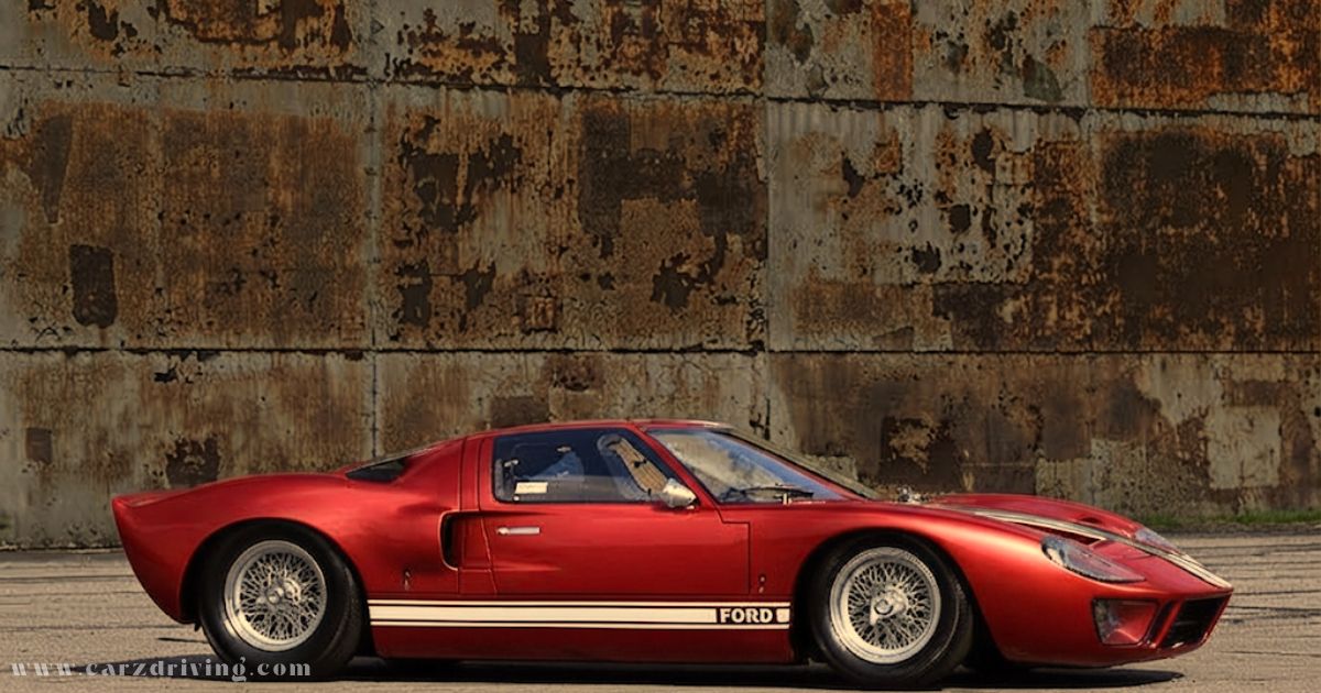 Classic metallic red Car Ford GT40 sports car side profile parked against a rustic wall
