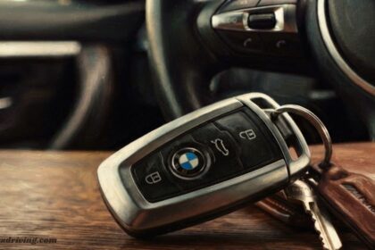 BMW smart key fob resting on a dashboard, illustrating car key replacement near me services.