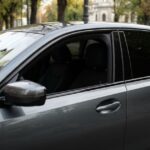 Professional side profile of a luxury vehicle equipped with high-quality car tinted glass for enhanced privacy and sun protection.