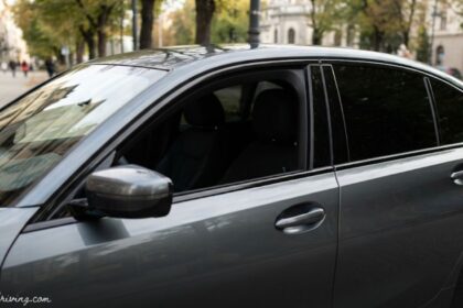 Professional side profile of a luxury vehicle equipped with high-quality car tinted glass for enhanced privacy and sun protection.
