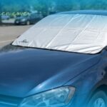 A high-quality car windscreen cover protecting the windshield of a blue vehicle from the sun.