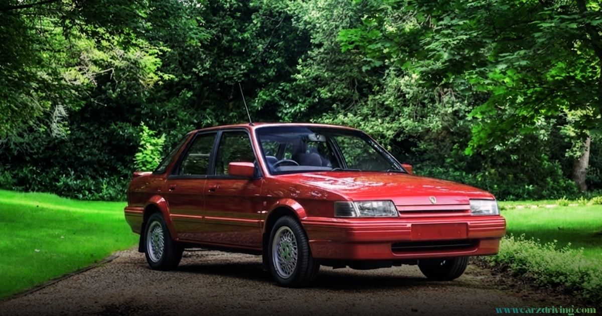 A red MG Montego sedan parked on a gravel driveway surrounded by lush green trees and foliage.