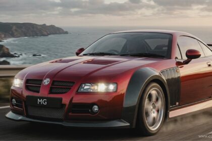 Front three-quarter view of a red performance mg sv sports car in motion on a cliffside road, featuring a rear spoiler and carbon fiber wheel arches.