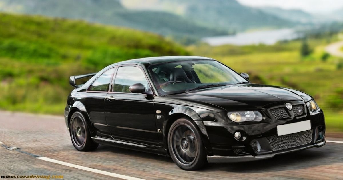 Side view of a black MG SV performance coupe in motion on a rural road, featuring a rear spoiler and alloy wheels.