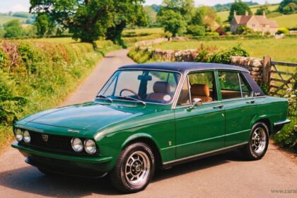 Vintage Triumph Dolomite sedan in green, parked on a countryside lane, perfect for classic car enthusiasts.