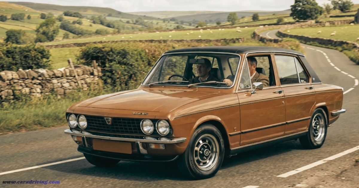 Classic brown Triumph Dolomite being driven on a rural road, representing vintage British automotive design.