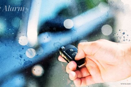 Hand pressing a button on a car alarm remote key fob with "Car Alarm" overlay text