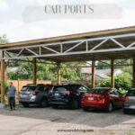 Large wooden and metal car ports structure protecting four vehicles in a residential driveway.