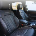 Premium black Lingvito car seat cover featuring a diamond-quilted stitch pattern installed on the front seats of a vehicle.