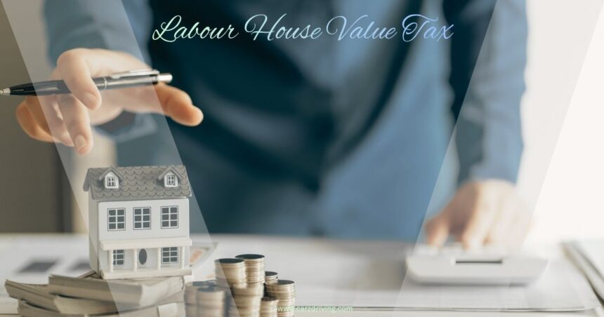 An image with the text "Labour House Value Tax" featuring a small model house surrounded by stacks of coins and paper money on a desk, with a person's hands hovering above the house and using a calculator in the background.