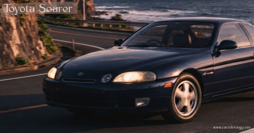 Dark blue Toyota Soarer coupe driving on a coastal road at sunset.