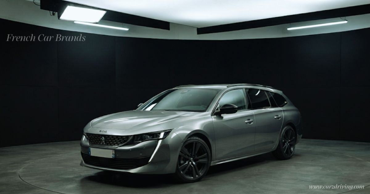 Front three-quarters view of a sleek silver Peugeot 508 SW station wagon sitting inside a dark-walled studio on a turntable floor, lit by soft overhead panel lights. Text reading "French Car Brands" appears in the upper left corner.
