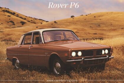 A vintage brown Rover P6 sedan parked in a grassy field with rolling hills in the background.