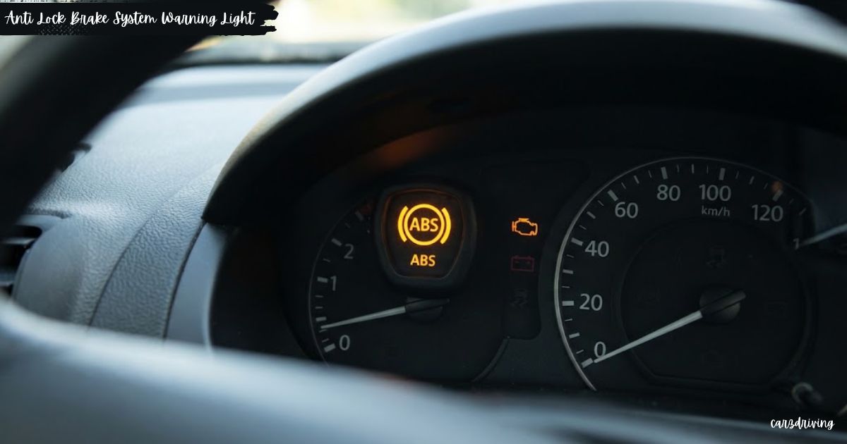 Yellow anti lock brake system warning light glowing on a vehicle dashboard.