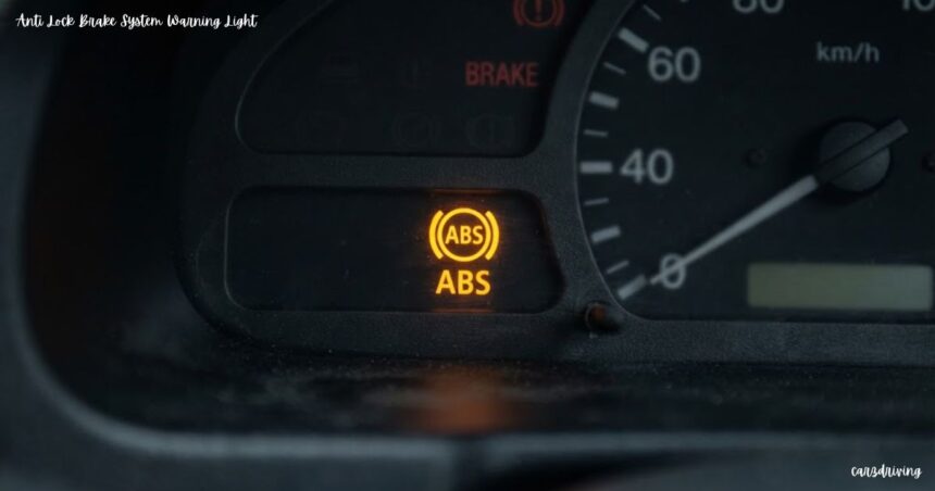Illuminated yellow anti lock brake system warning light on a car dashboard cluster.