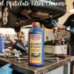 Liqui Moly diesel particulate filter cleaner bottle on a workbench in a car repair shop.