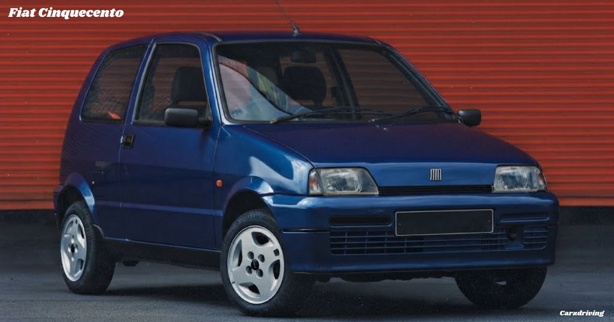 Front three-quarter view of a dark blue classic Fiat Cinquecento hatchback parked against a red shutter backdrop.