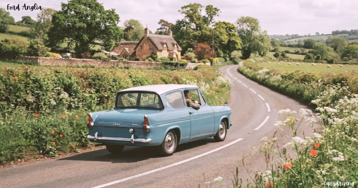 A vintage turquoise and white Ford Anglia driving along a winding country road flanked by green hedges and rolling English countryside hills.