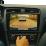 Reverse camera system for car displaying parking guidelines on a center console screen.