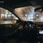 Fogged-up car windshield and rainy windows at night illustrating how to stop car windows from fogging up. and how to stop car from fogging up lay at the corner