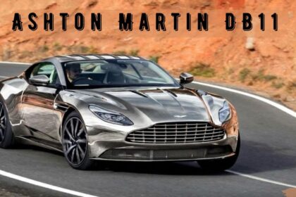 Silver Aston Martin DB11 sports car driving along a winding mountain road