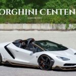 White Lamborghini Centenario Roadster convertible hypercar parked on pavement.