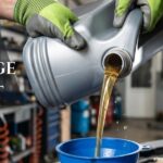 Mechanic pouring fresh motor oil into a funnel with text reading oil change cost