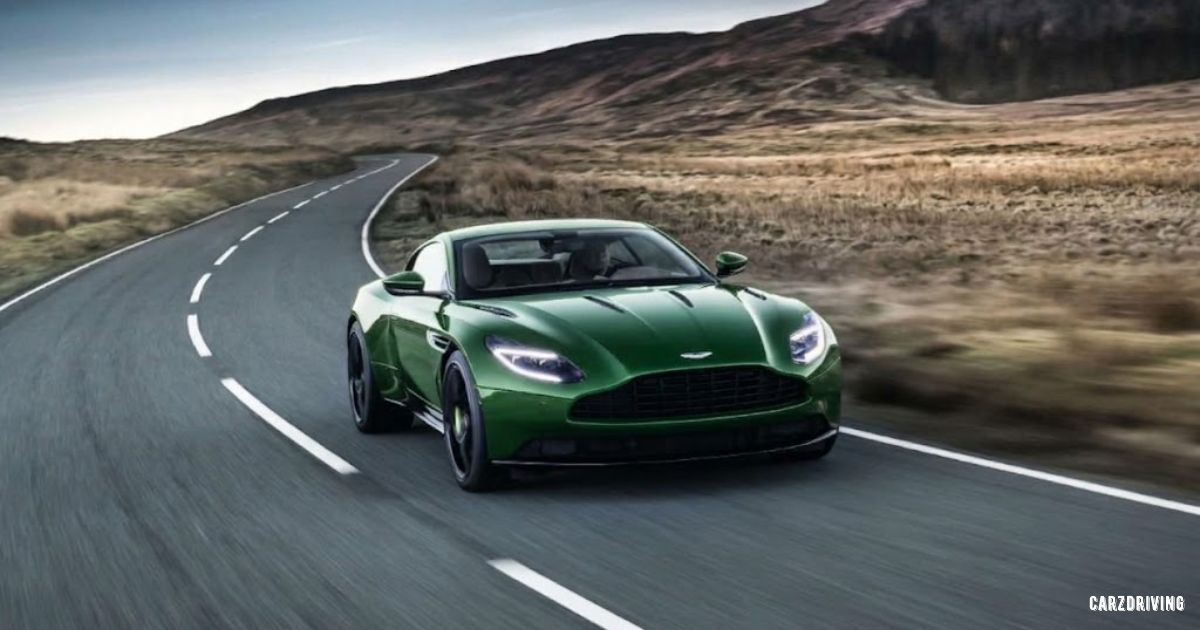 Green Aston Martin DB11 sports car driving on a scenic country road