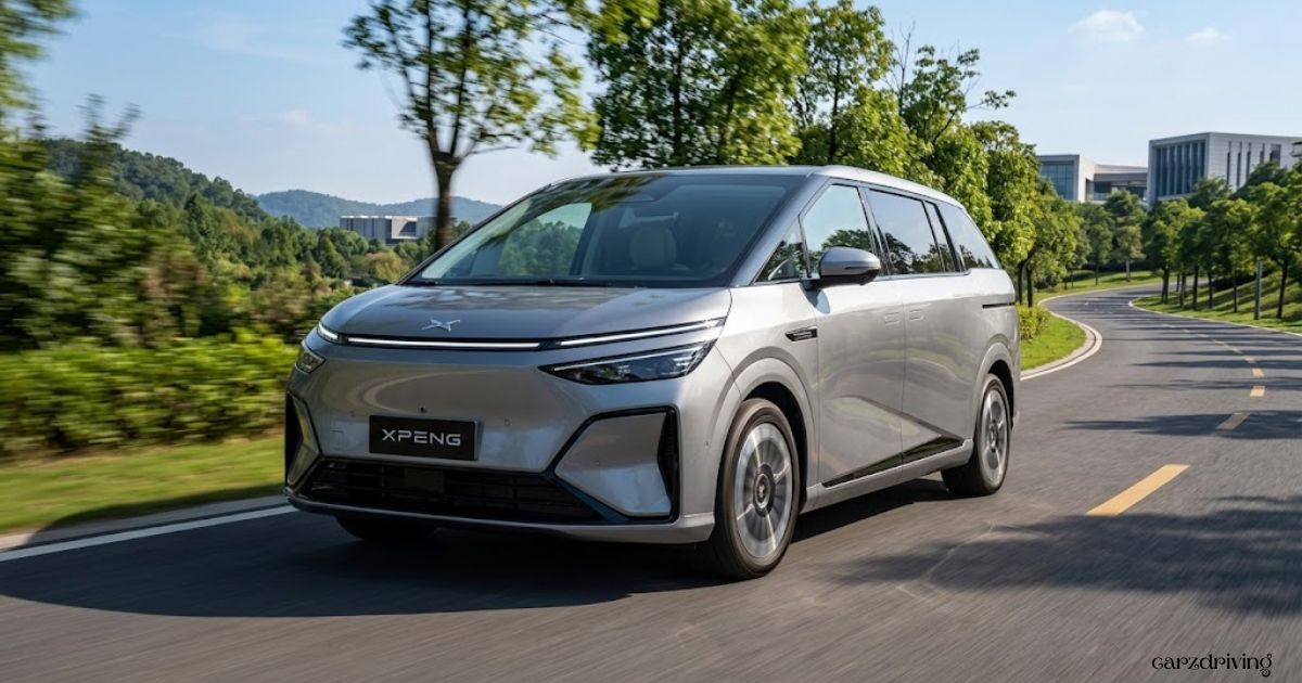 Silver XPeng X9 electric MPV driving along a winding scenic road